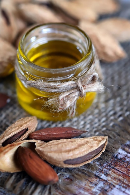 Almond oil in a jar Almonds in shells