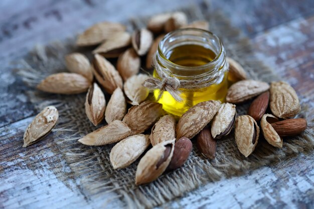 Almond oil in a jar Almonds in shells