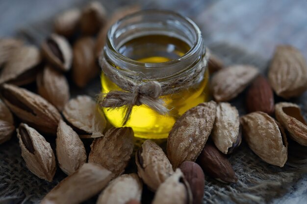 Almond oil in a jar Almonds in shells