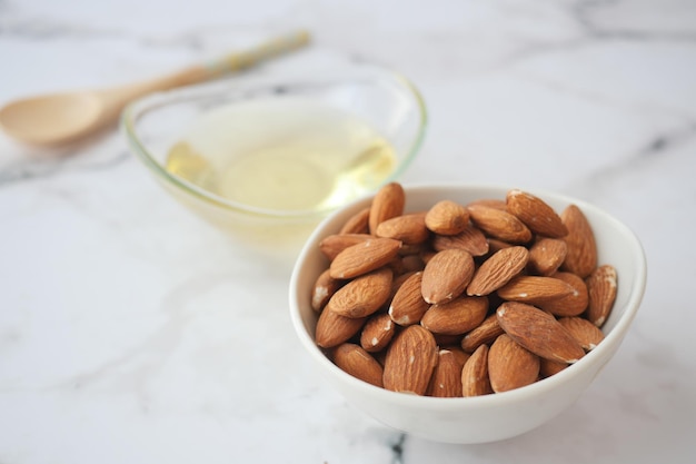 Almond oils and fresh nuts on table