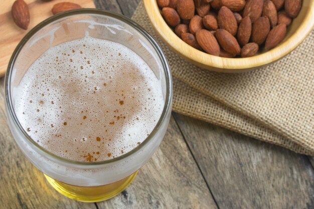 almond peanut and beer on table