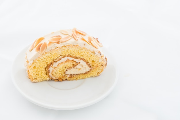 Almond roll cake on white dish