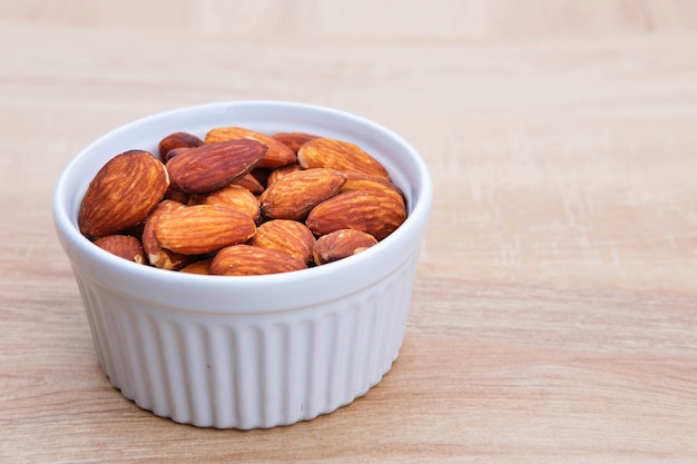 Almond seeds for health on wooden table