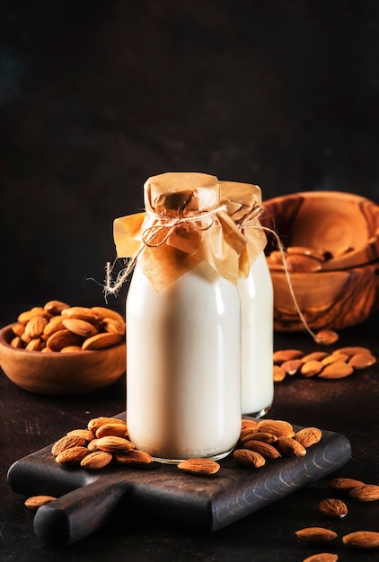 Almond vegan alternative milk with nuts on brown table with cjopy space