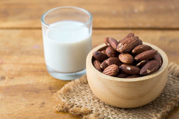 almond with milk on wooden background