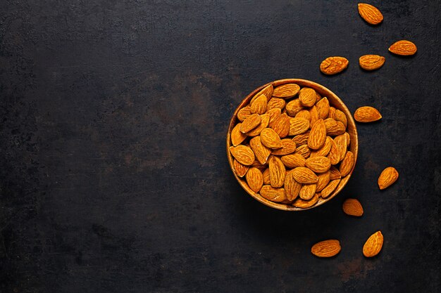 Almond in wooden bowl standing on rustic