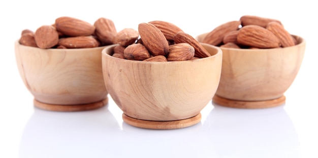 Almond in wooden bowls isolated on white