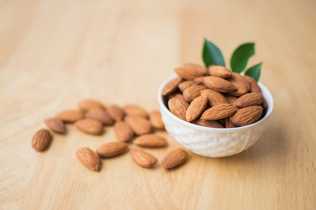 Almond on wooden table. soft focus.