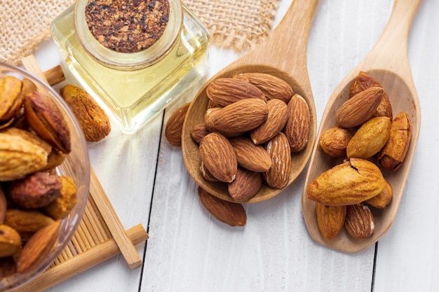 Almonds in a black bowl against dark rustic wooden space