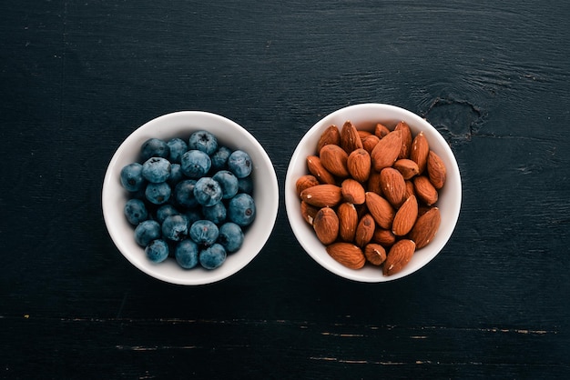 Almonds and blueberries On a wooden background Top view Free copy space