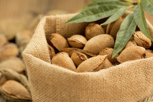 Almonds on brown wooden background