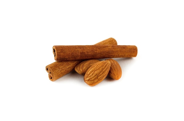 Almonds and cinnamon sticks isolated on white background