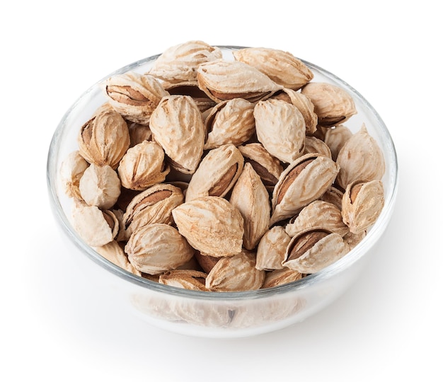 Almonds in glass bowl isolated on white background with clipping path