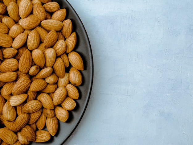 Almonds on light blue table, Top view.