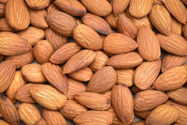 Almonds nuts on background Close up delicious sweet almonds top view roasted almond nut for healthy food and snack