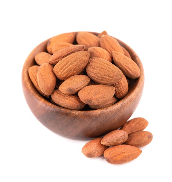 Almonds nuts in wooden bowl, isolated on white background. Pile of fried almond nuts. Top view.