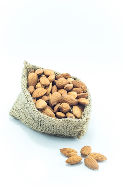 Almonds in sack isolated on white background