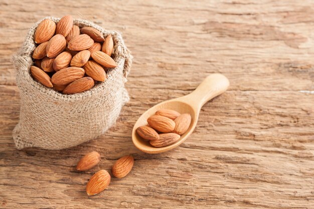 Almonds in sack on wooden table