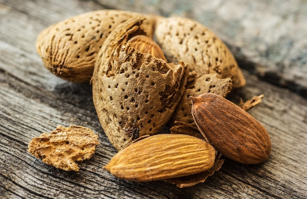 Almonds in shell and peeled almond copy space