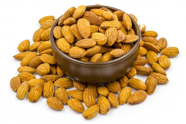 Almonds with bowl on the white background. 