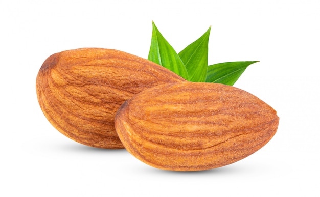 Almonds with leaves on white wall . 