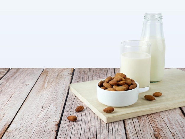 Almonds with milk on wooden texture background