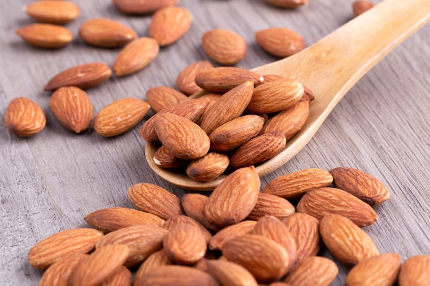 Almonds in a wooden spoon on the table