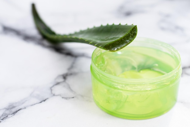Aloe leaf and gel on a marble background with copy space\
moisturizing recovery and caring for the skin