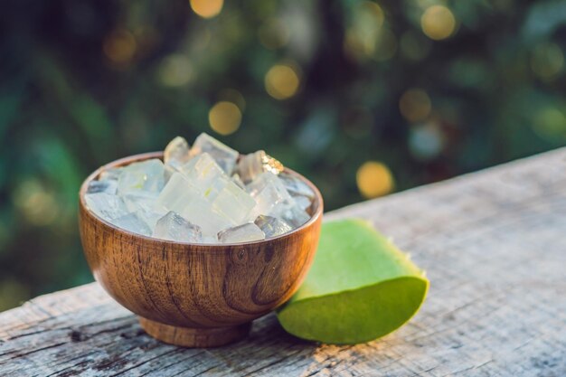 Aloe vera and aloe cubes in a wooden bowl. Aloe Vera gel almost use in food, medicine and beauty industry