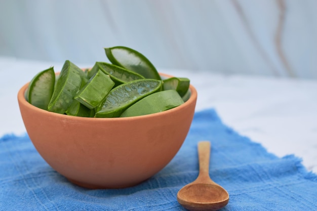 Aloe vera bowl with wooden spoon on the side for skin care Healthy lifestyle concept