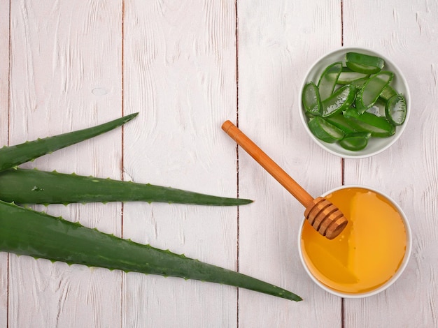 Aloe Vera and honey closeup on light wooden background