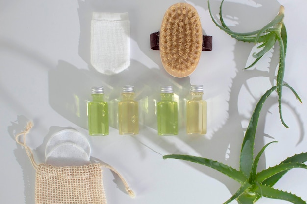 Aloe vera is a natural organic care product. Top view of green aloe vera leaves spread out on a table with various cosmetic products demonstrating the concept of natural skin care.