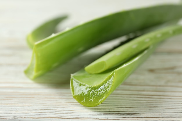 Aloe vera leaves on white wooden background