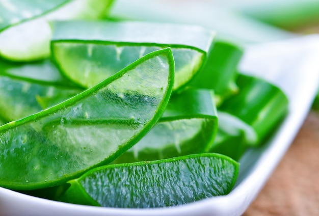 Aloe Vera leaves on wooden background