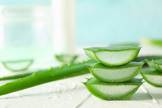 Aloe vera slices on white wooden table