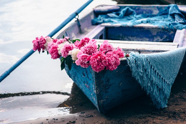 alone blue boat on the river, decorated with flowers