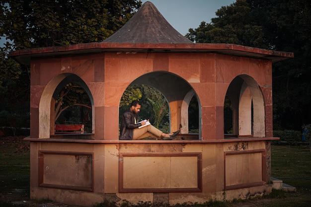 Alone boy studying in park at morning