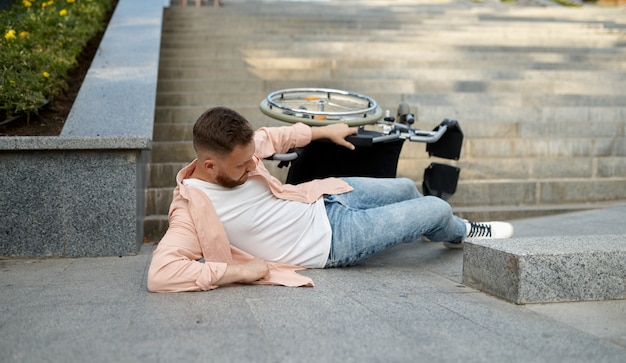 Photo alone disabled man fell out of a wheelchair