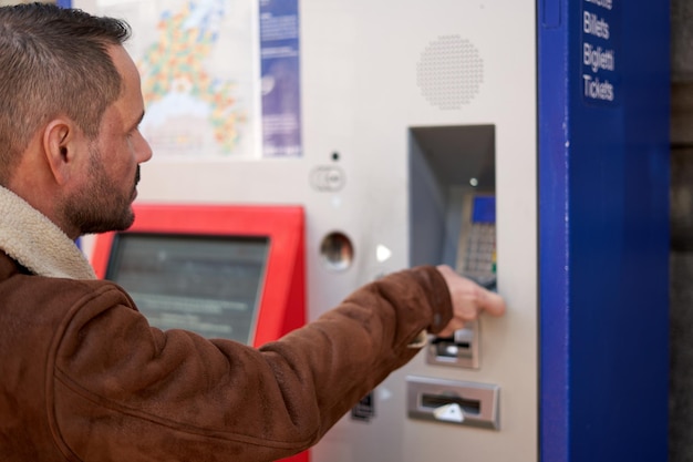 alone man buying a train ticket