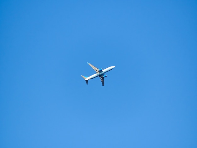 Alone plane in blue day sunny sky minimalism background