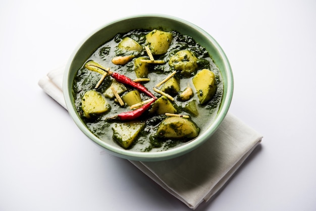 Aloo Palak sabzi or Spinach Potatoes curry served in a bowl. Popular Indian healthy recipe. Selective focus