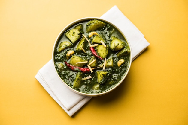 Aloo Palak sabzi or Spinach Potatoes curry served in a bowl. Popular Indian healthy recipe. Selective focus