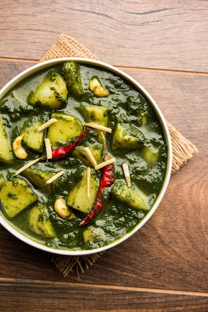 Aloo Palak sabzi or Spinach Potatoes curry served in a bowl. Popular Indian healthy recipe. Selective focus