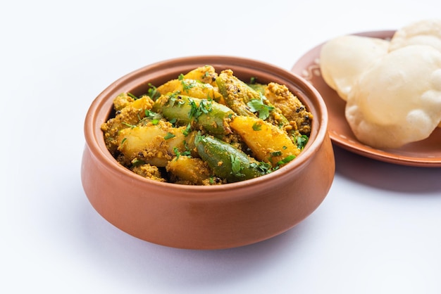 Aloo Patol sabzi made using pointed gourd and potato served with fried Luchi or poori Bengali food