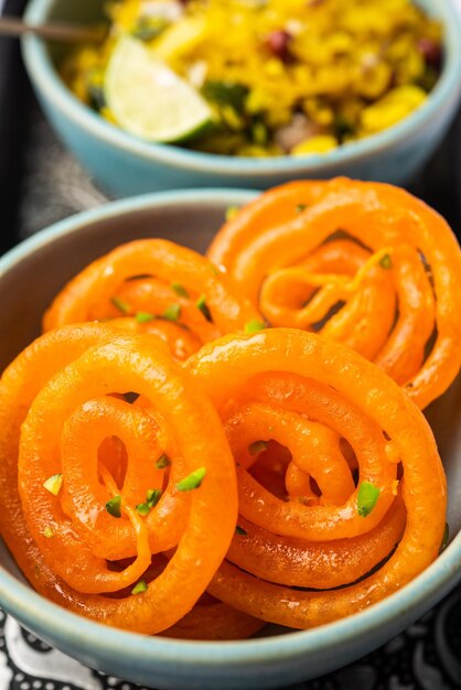 Photo aloo poha with jalebi snack combination also called imarti and kande pohe