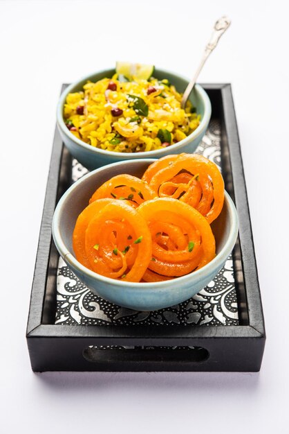 Photo aloo poha with jalebi snack combination also called imarti and kande pohe