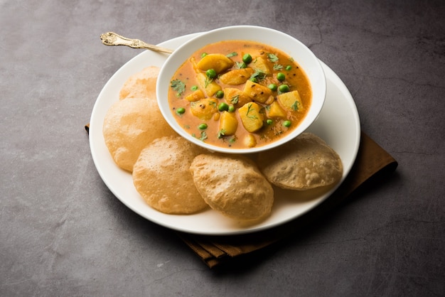 Aloo Puri or Potato curry with fried Poori, popular Indian breakfast or lunch or dinner menu.