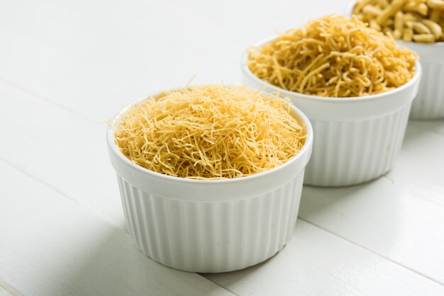 Aloo Sev or Namkeen snack is made from mashed potatoes, chickpea flour and spices, selective focus