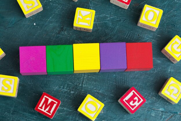 Alphabet blocks ABC on wooden table.