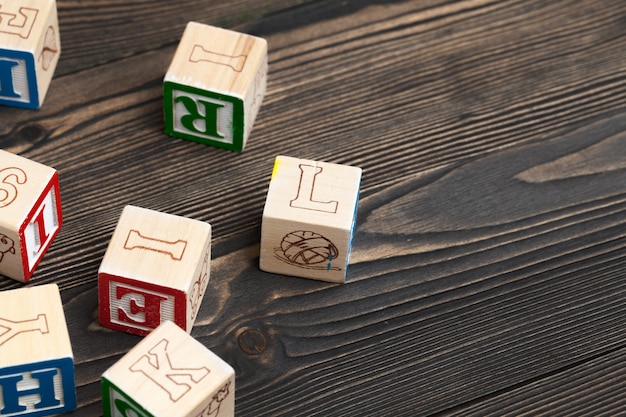 Alphabet blocks ABC on wooden table.